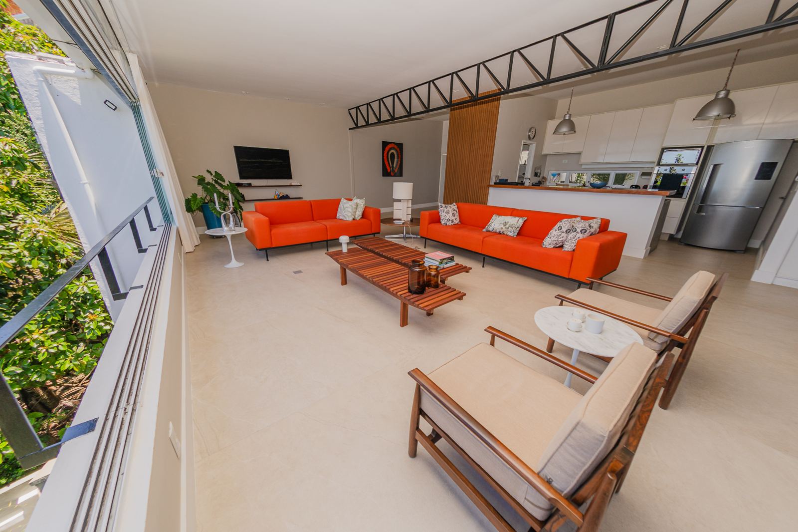 Salon de Vila Oriba vu depuis la terrasse, cuisine ouverte au fond